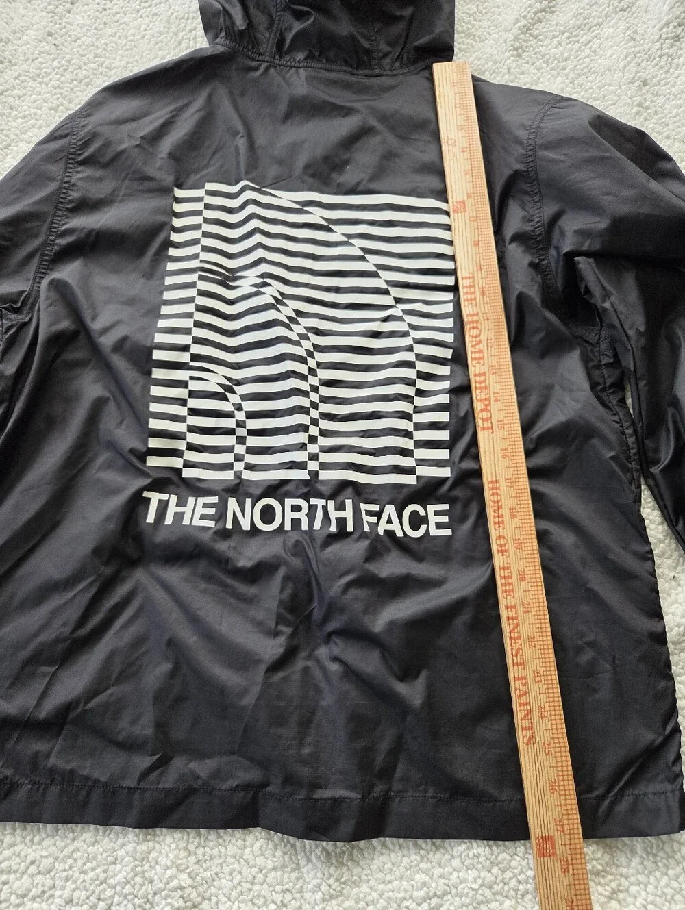 The North Face Optical Cyclone windbreaker features a distinctive optical illusi